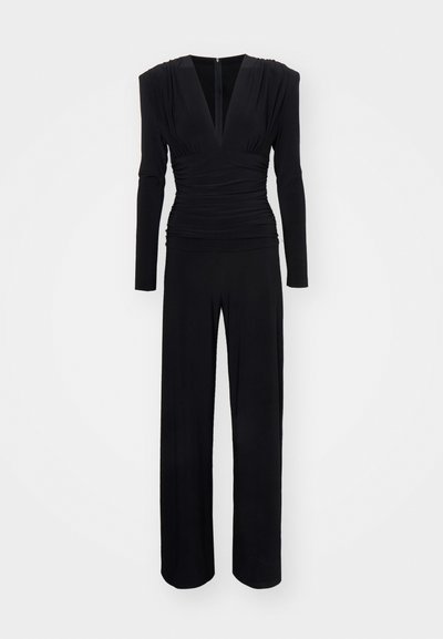 Black jumpsuit with long sleeves, a deep V-neck, ruched detailing at the waist, and wide pants. Smooth, stretchy fabric with a zip closure.