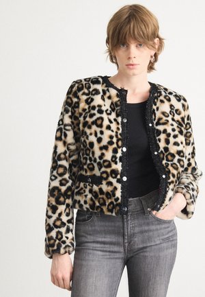 Leopard-print faux fur jacket with black trim and buttons, long sleeves, and deep pockets, paired with gray jeans.