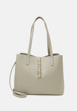 Light beige tote bag made of textured leather, featuring embossed logo design and a gold-tone hardware accent. Two shoulder straps included.