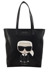 Black leather tote bag featuring a cartoon character with white hair and sunglasses, prominently displayed on the front in a contrasting design.