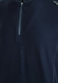 Mariene zip-up top van soepel materiaal, met een korte rits en platte naden. Minimalistisch ontwerp zonder zichtbare patronen of prints.