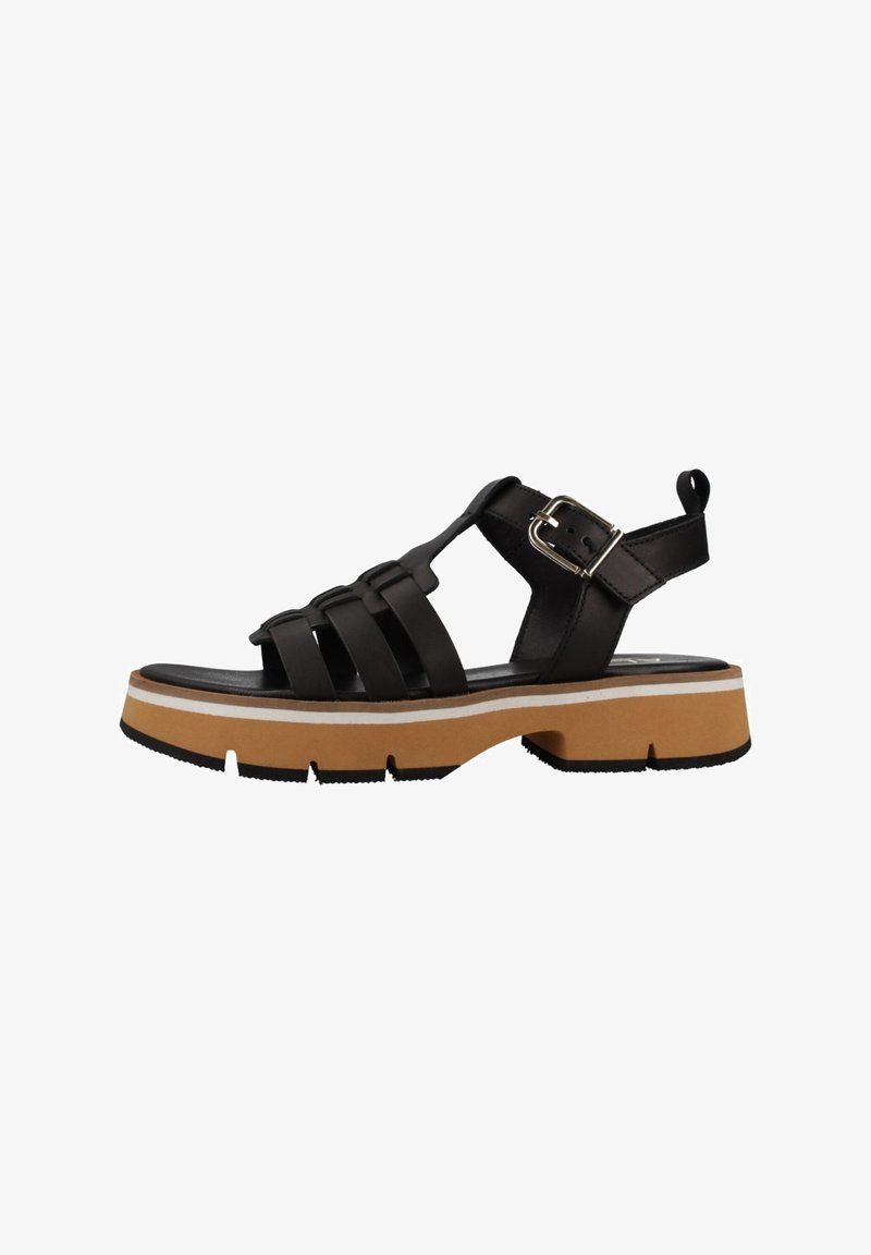 Sandalias negras de tiras con una suela gruesa color tostado, tiras texturizadas, hebilla ajustable y una pestaña en la parte trasera para ponerlas y quitarlas fácilmente.