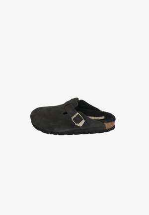 Clogs made of black suede with a cork footbed. Features a single adjustable strap with a silver buckle. Soft, textured interior.