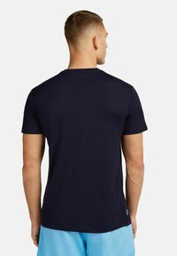 Navy blue T-shirt made of soft fabric, featuring a classic crew neck and short sleeves. Back view with a small logo tag at the hem.