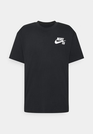 T-shirt noir à manches courtes avec logo Nike SB blanc sur la poitrine gauche et un col rond sur un fond uni.