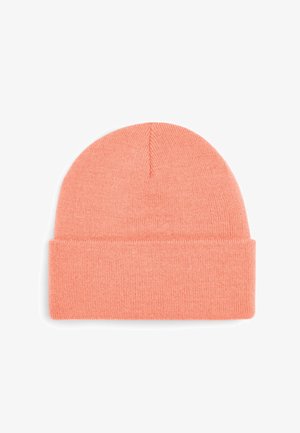 Knit beanie in soft coral color with a folded cuff and seamless crown. Material appears warm and textured, suitable for cold weather.