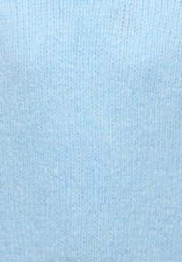 Svetlo modra pletena tkanina z mehko teksturo, značilnim enakomernim in gladkim vzorcem. Brez vidnih šivov ali okraskov.