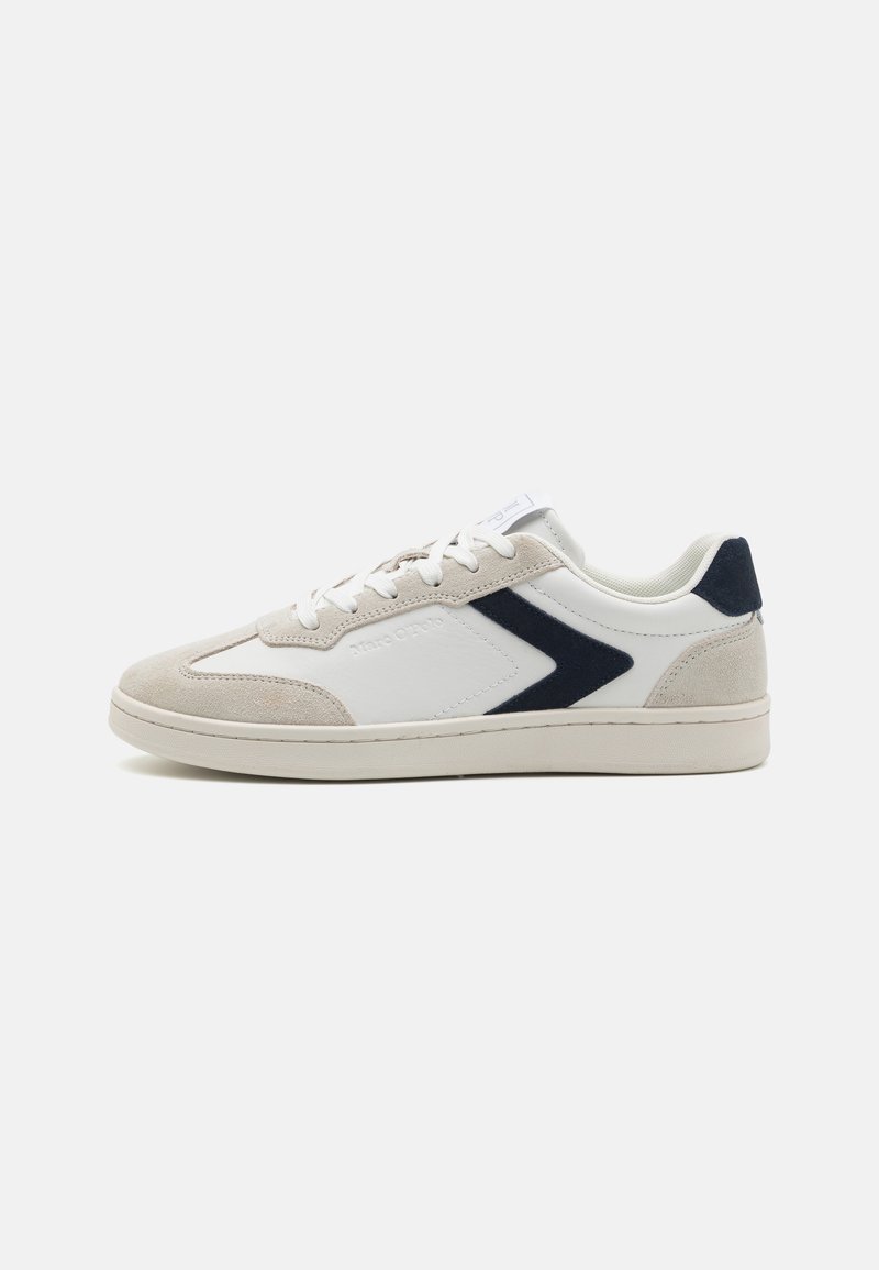White leather and beige suede sneaker with navy accents, lace-up design, flat rubber sole, and a textured toe cap.