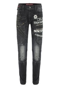 Zwarte denim jeans met decoratieve studs, ritsen en gedurfde geborduurde patches. Slim fit met gestructureerde accenten en gewatteerde panelen.
