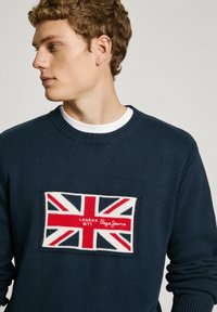 Navy knitted sweater featuring a red, white, and blue Union Jack patch with "LONDON W11" and "Pepe Jeans" text on the front.