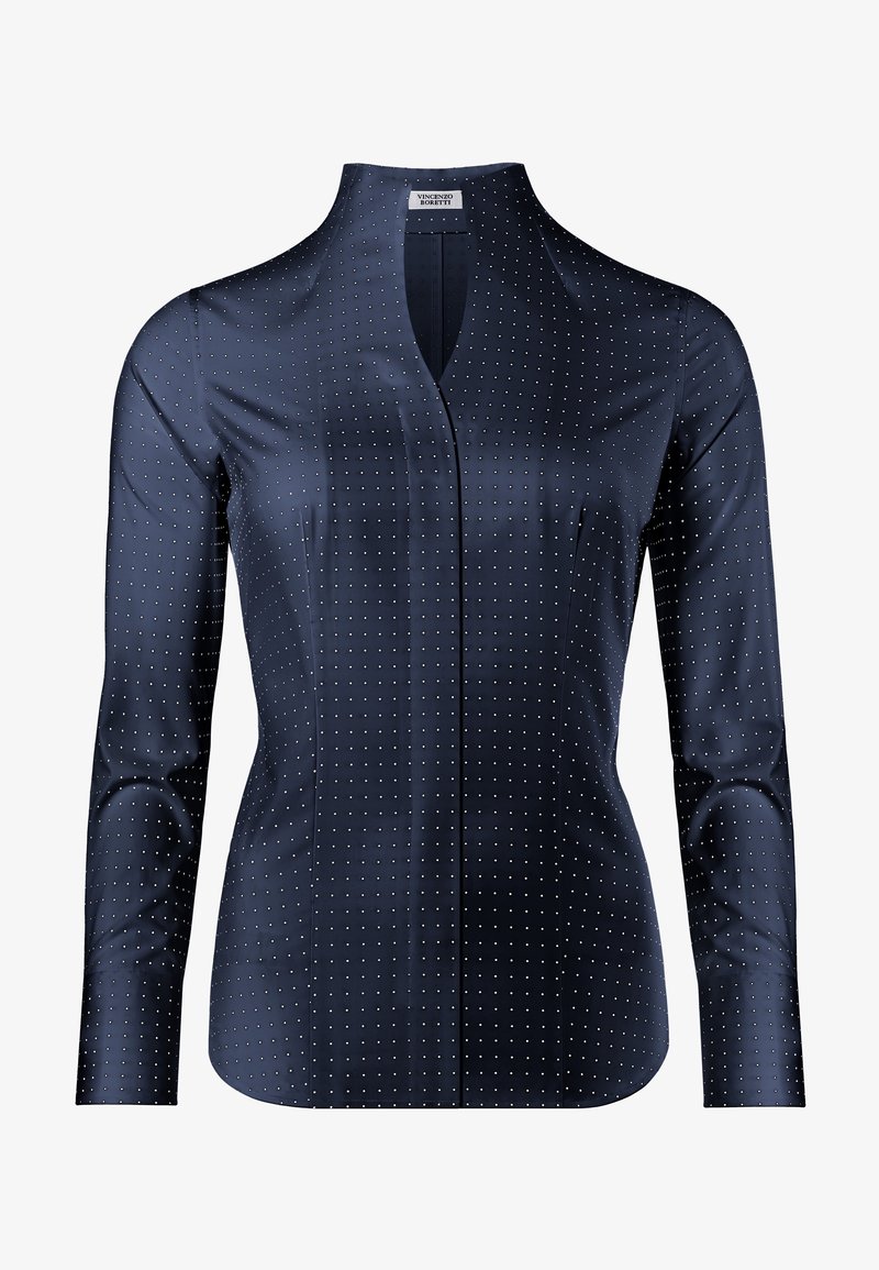 Blusa blu navy con maniche lunghe, scollo a V e una texture liscia. Presenta un motivo a pois bianchi, vestibilità strutturata con dettagli sottili.