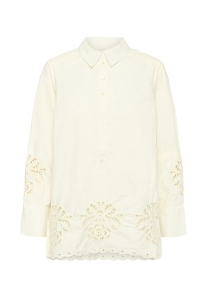 Blouse crème à manches longues avec col, patte de boutonnage sur le devant et broderie florale en œillets sur les manches et l'ourlet.