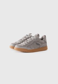 Gray suede sneakers with rubber sole, featuring rounded toe, lace-up closure, and subtle logo detail on the side.