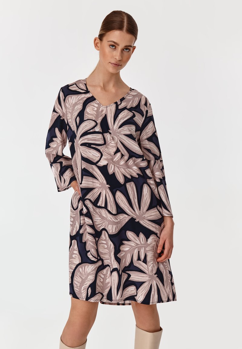 Navy V-Ausschnitt-Kleid mit blassröslicher botanischer Druck, langen Ärmeln, knielanger Länge, leichtem Stoff und Seitentaschen.