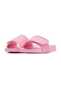 Pink slide sandals with broad straps featuring a textured surface and white logo. The material appears soft and flexible, suitable for casual wear.