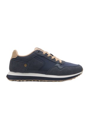 Zapatilla casual de color azul oscuro y beige con suela blanca y azul marino, diseño con cordones y detalle texturizado en el talón con pequeño emblema de estrella.