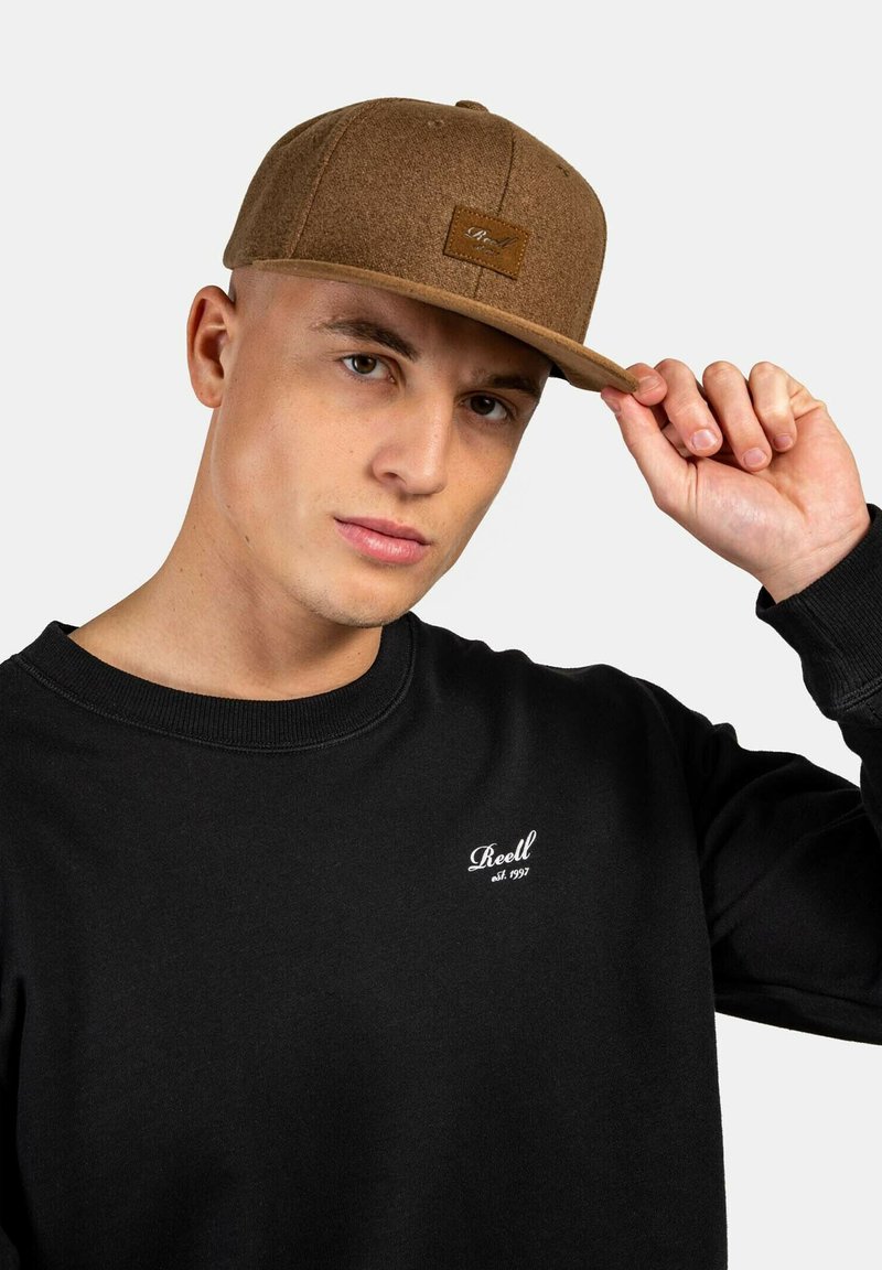 Brown wool blend cap with a flat brim and stitched logo patch; worn with a black sweatshirt featuring white logo embroidery.