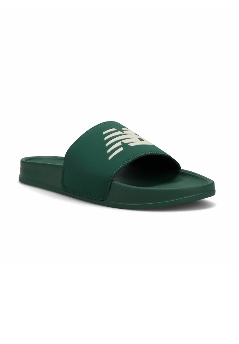 Green slide sandal made of rubber. Features a wide strap with a white logo, flat sole, and smooth texture. Simple, open-back design.