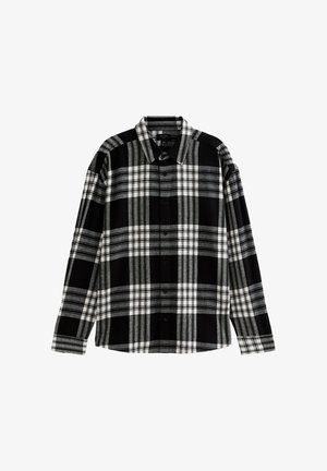 Chemise à carreaux noir et blanc avec manches longues, col, fermeture à boutons sur le devant et texture de tissu douce. Présente des rayures alternées épaisses et fines.