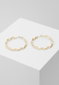 Gold hoop earrings with a twisted design, featuring textured detailing along the surface and a secure clasp closure.