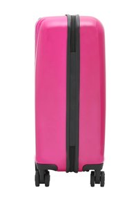 Hard-shell suitcase in glossy pink, with a black zipper and accent. Features four rolling wheels for mobility. Rectangular shape, smooth texture.