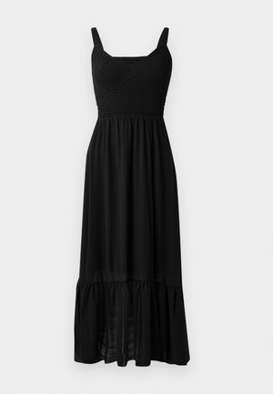 Black maxi dress featuring a smocked bodice, adjustable straps, and a tiered ruffle hem. Made from lightweight, flowing fabric with a smooth texture.