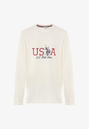 T-shirt a maniche lunghe in cotone crema con grafica rossa e blu navy "USA" con design di un giocatore di polo e testo "U.S. Polo Assn." sottostante.