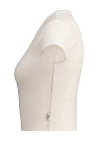 Top a maniche corte color crema a coste con un design aderente. Presenta un colletto rotondo e un piccolo etichetta di marca sulla cucitura laterale.