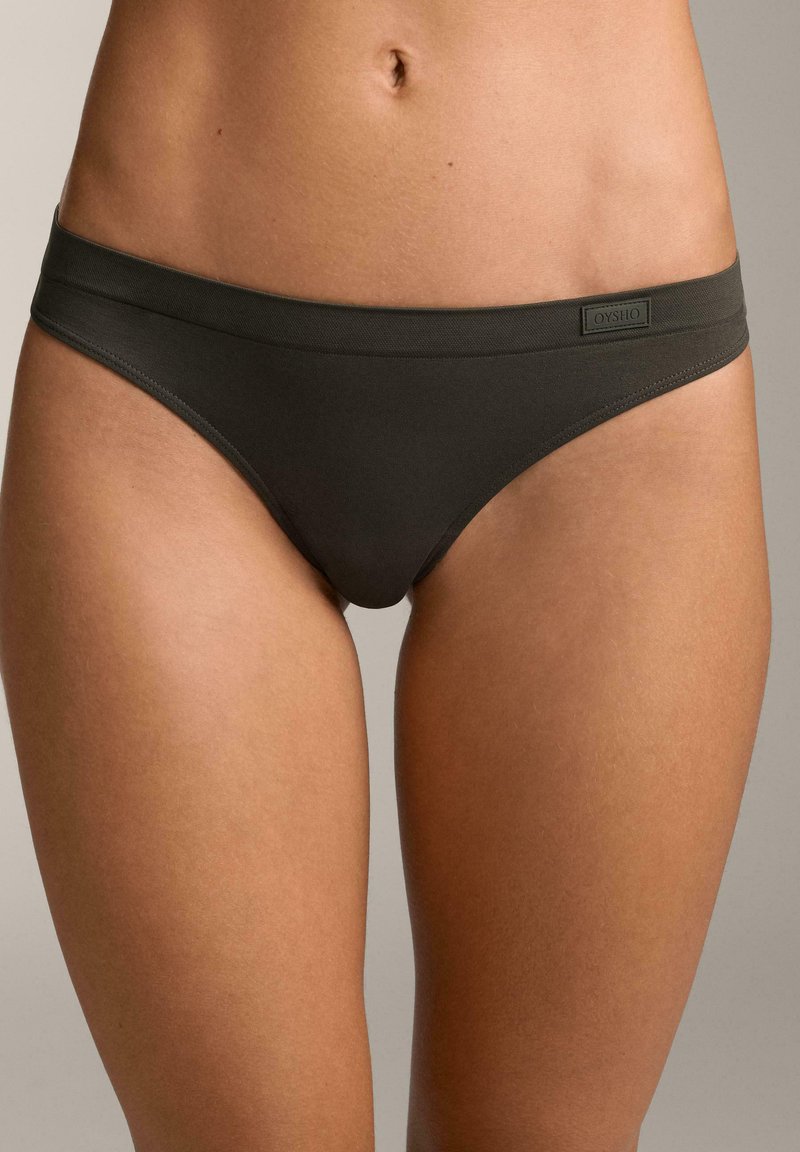Bikini in cotone verde scuro con una texture liscia, design a vita bassa e un elastico con marchio. Presenta uno stile minimalista e linee pulite.