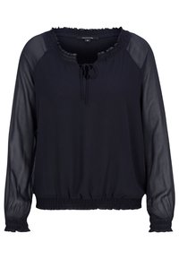 Top blu navy con scollatura a volant, dettaglio con stringa e maniche lunghe trasparenti. La vita e i polsini elasticizzati creano una vestibilità rilassata.