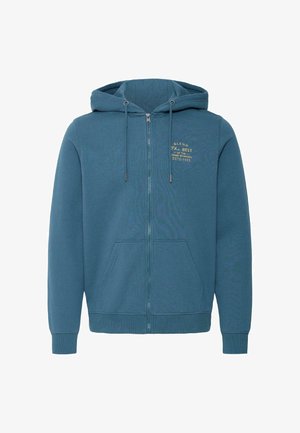 Sweat à capuche bleu zippé avec cordon de serrage, poches avant, et petit texte jaune à gauche de la poitrine indiquant "B.L.E.N.D The Best of the Denim Workers Estd 1993."