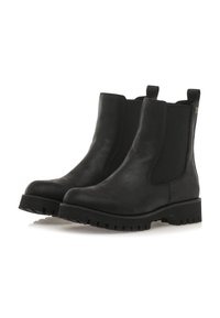 Botines de cuero negro hasta el tobillo con paneles elásticos en los costados, punta redondeada y suela de goma resistente. Presentan tiradores para poner y quitar fácilmente.