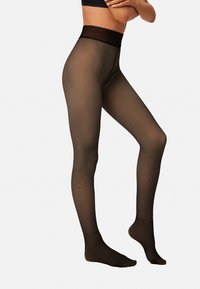 Medias marrones transparentes con una textura suave, una cintura elástica ancha y un diseño con pies, con patrones sutiles a lo largo de las piernas.