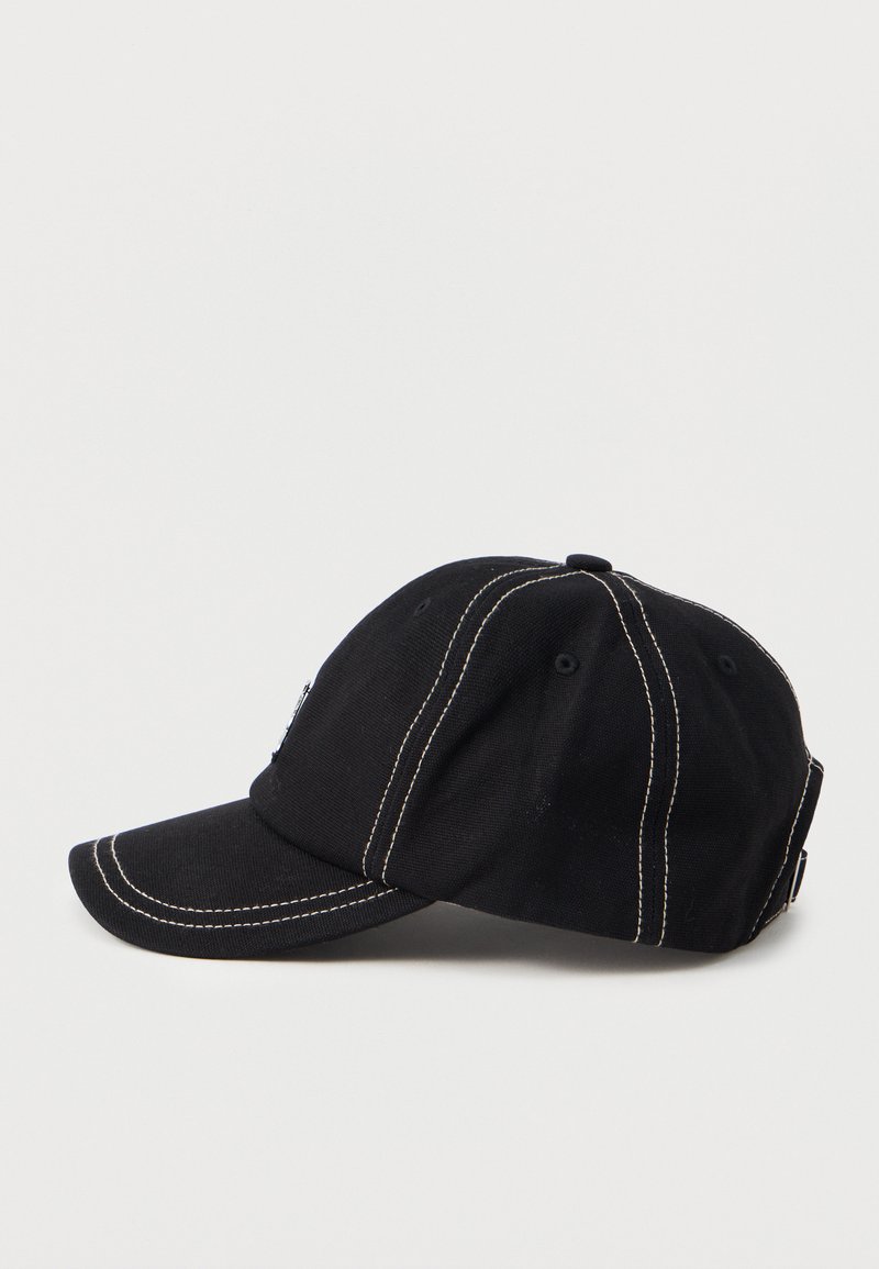 Black baseball cap with white contrast stitching and adjustable strap, shown in side profile on white background.