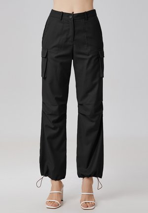 SAFARI À COULISSES - Pantalon cargo - noir