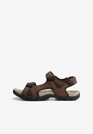 Brown outdoor sandal featuring a leather upper with mesh panels, adjustable straps, and a cushioned footbed on a black rubber sole.