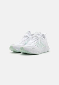 Pair of white and mint green low-top sneakers with textured soles, lace-up fronts, and branded EA7 logos on tongues and sides.
