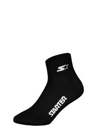 Czarna skarpetka za kostkę wykonana z gładkiej tkaniny z prążkowanym ściągaczem. Z białym napisem „STARTER” i logo po boku.