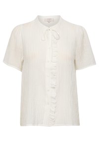 Blouse crème à manches courtes avec un col rond, tissu texturé, fermeture à boutons sur le devant et détail volanté le long de la patte de boutonnage.