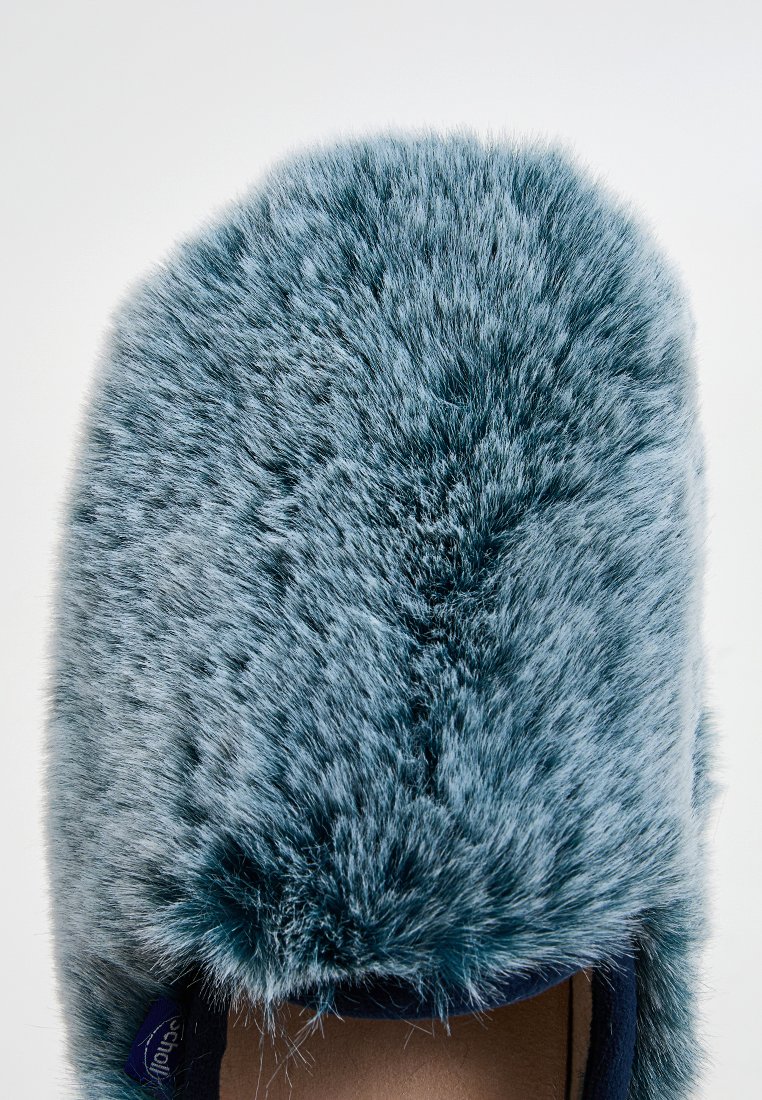 Pantofole in pelliccia sintetica con un design a punta arrotondata. La parte superiore è in un morbido e denso materiale blu con una consistenza liscia, caratterizzata da una base scura solida.