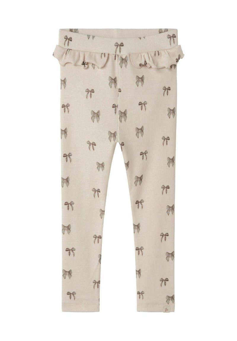 Leggings beige chiaro con una texture a coste, decorati con un motivo di fiocchi ripetuto in marrone tenue. Include un dettaglio con vita arricciata.