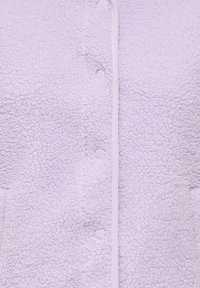 Lilakas fliša jaka ar teksturētu, pūkainu virsmu, pogu aizdari un kontrastējošu baltu apmali priekšpusē.