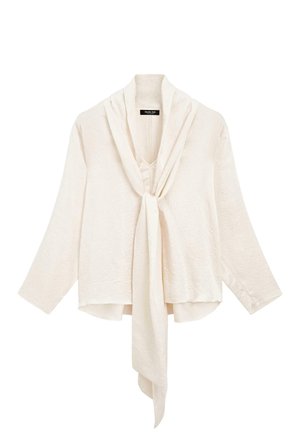 Blouse blanche légère avec des manches longues et un nœud à l'avant. Présente un col drapé et un tissu texturé pour plus de détails.