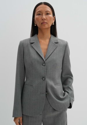 Gray pinstripe blazer with notch lapels, two front pockets, and two buttons. Textured fabric with a tailored fit.