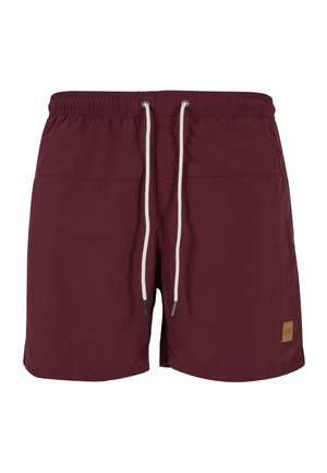 Bordeaux badebukser med elastisk talje, hvid snor og et lille brunt logo-patch. Glat tekstur og længde under knæet.