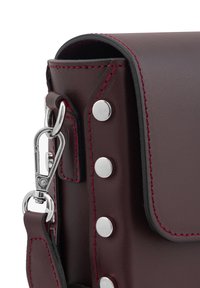 Leder-Schultertasche in tiefburgunder mit silbernen Metallbeschlägen, roten Nähte und Druckknopf-Details. Glatte Textur mit strukturiertem Design.