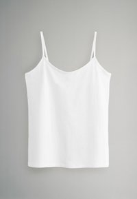 Balta, be rankovių kemšė su plonomis petnešomis ir lygiu paviršiumi. Paprastas dizainas, su apvaliu iškirpimu ir tiesiu kraštu.