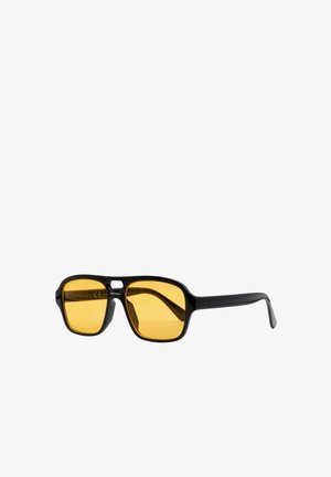 Occhiali da sole neri con montatura quadrata e lenti gialle. La montatura presenta una texture sottile, con un design minimalista e senza branding visibile.