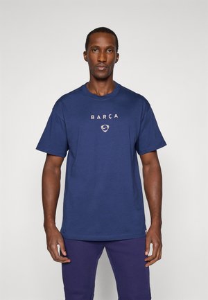 Navy blue cotton t-shirt with short sleeves, featuring "BARÇA" and a Nike logo in white on the chest, crew neck design.