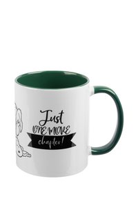 Tazza in ceramica bianca con interno e manico verde. Presenta un disegno in stile cartoon e il testo "Solo un capitolo in più!" in nero.